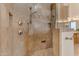 Tiled shower with dual shower heads, convenient built-in shelves, and a glass enclosure at 2998 E Waterman Way, Gilbert, AZ 85297