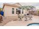 Charming backyard patio with seating, shade, and manicured gravel beds, perfect for relaxation at 316 W Kelton Ln, Phoenix, AZ 85023