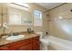 Bathroom with vanity with granite countertop, bath tub and shower at 316 W Kelton Ln, Phoenix, AZ 85023