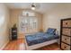 Bedroom with wood floors, bright light, and window shutters at 316 W Kelton Ln, Phoenix, AZ 85023