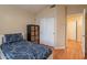 Bedroom with bed and basketweave storage next to closet with sliding doors at 316 W Kelton Ln, Phoenix, AZ 85023