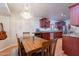 Dining area adjacent to the kitchen, featuring wood table, chandelier, and wood cabinets at 316 W Kelton Ln, Phoenix, AZ 85023