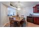 Dining area with wood table, chandelier, and convenient access to the kitchen and living spaces at 316 W Kelton Ln, Phoenix, AZ 85023