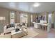 Bright home office with backyard access, wood floors, modern furnishings, and white shelving at 316 W Kelton Ln, Phoenix, AZ 85023