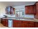 Close-up of kitchen featuring granite countertops, stainless steel appliances, and wood cabinets at 316 W Kelton Ln, Phoenix, AZ 85023