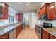 Spacious kitchen with stainless steel appliances, granite countertops, and wood flooring at 316 W Kelton Ln, Phoenix, AZ 85023