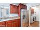 Kitchen with stainless steel refrigerator, granite countertops, and access to the laundry room at 316 W Kelton Ln, Phoenix, AZ 85023