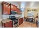 Open kitchen with stainless steel appliances, granite countertops, and a view into the dining area at 316 W Kelton Ln, Phoenix, AZ 85023