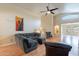 Bright living room with a vaulted ceiling, wood floors, and a large sofa at 316 W Kelton Ln, Phoenix, AZ 85023