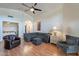Comfortable living room showcasing a vaulted ceiling, wood floors, and ample seating at 316 W Kelton Ln, Phoenix, AZ 85023