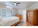 Bright main bedroom featuring wood floors, ceiling fan, and an en-suite bathroom at 316 W Kelton Ln, Phoenix, AZ 85023