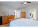 Comfortable main bedroom featuring wood furniture, ceiling fan, and an en-suite bathroom at 316 W Kelton Ln, Phoenix, AZ 85023
