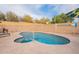 Backyard pool with patio seating, privacy wall, and decorative donkey statue at 316 W Kelton Ln, Phoenix, AZ 85023