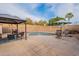 Backyard pool area featuring a gazebo, lounge chairs, and well-maintained landscaping at 316 W Kelton Ln, Phoenix, AZ 85023