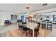 Open concept dining room featuring modern lighting, wood floors, and access to the kitchen at 3429 E Indianola Ave, Phoenix, AZ 85018