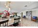 Open dining area with modern light fixture, wood-look floors, and seamless access to the living room at 3429 E Indianola Ave, Phoenix, AZ 85018