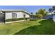 Well-maintained front yard featuring lush green grass, mature trees, and brick facade at 3429 E Indianola Ave, Phoenix, AZ 85018