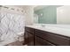 Bright bathroom with a shower and tub combination and wood look floors at 37295 W Cannataro Ln, Maricopa, AZ 85138