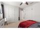 Bedroom with neutral carpet, ceiling fan, and dual access doors at 37295 W Cannataro Ln, Maricopa, AZ 85138