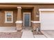 Close-up of the front door with stone accents on the porch columns at 37295 W Cannataro Ln, Maricopa, AZ 85138