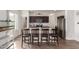 Kitchen island with barstool seating, granite countertops, and stainless steel appliances at 37295 W Cannataro Ln, Maricopa, AZ 85138