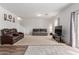 Spacious living room with plush carpeting and comfortable seating arrangement at 37295 W Cannataro Ln, Maricopa, AZ 85138