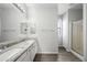 Bright bathroom featuring double sinks, granite counters and a walk-in shower at 40975 N Arbor Ave, San Tan Valley, AZ 85140