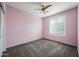 Bedroom with plantation shutters, plush carpet, ceiling fan and closet at 40975 N Arbor Ave, San Tan Valley, AZ 85140
