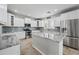 Modern kitchen with white cabinetry, granite countertops, stainless steel appliances, and an island at 40975 N Arbor Ave, San Tan Valley, AZ 85140
