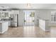 Open-concept kitchen with stainless steel refrigerator, bar seating, and sliding glass doors at 40975 N Arbor Ave, San Tan Valley, AZ 85140