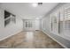 Bright living room with tile flooring, white door and staircase with window shutters at 40975 N Arbor Ave, San Tan Valley, AZ 85140