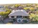 Beautiful aerial view of a home with an outdoor living space and a pool, surrounded by lush desert landscaping at 42019 N Golf Crest Rd, Anthem, AZ 85086