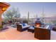 Outdoor patio with comfortable seating, a fire pit, and views of the surrounding landscape at 42019 N Golf Crest Rd, Anthem, AZ 85086
