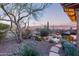 Beautiful backyard featuring pool, firepit, desert landscaping, and sunset views at 42019 N Golf Crest Rd, Anthem, AZ 85086