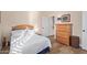 Bedroom featuring a wood-framed bed, light hardwood floors, and natural lighting at 42019 N Golf Crest Rd, Anthem, AZ 85086