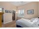 Comfortable bedroom with shuttered windows, wood floors, and view into large closet at 42019 N Golf Crest Rd, Anthem, AZ 85086