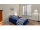 Cozy bedroom features shuttered windows, wood floors, and a comfortable bed at 42019 N Golf Crest Rd, Anthem, AZ 85086