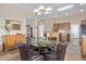 Bright dining room featuring a glass table, leather chairs, and wood floors and cabinets at 42019 N Golf Crest Rd, Anthem, AZ 85086