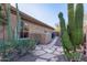 Charming home exterior features desert landscaping with cacti and a stone pathway leading to a private gate at 42019 N Golf Crest Rd, Anthem, AZ 85086