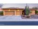 Charming home featuring a three-car garage, desert landscaping, and a striking saguaro cactus at 42019 N Golf Crest Rd, Anthem, AZ 85086