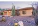 Southwest home showcasing desert landscaping with rocks and native cactus and 3 car garage at 42019 N Golf Crest Rd, Anthem, AZ 85086