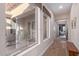 Light-filled hallway with large windows offering views of the outdoor courtyard at 42019 N Golf Crest Rd, Anthem, AZ 85086