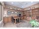 Spacious home office features custom built-in shelving and wood desk at 42019 N Golf Crest Rd, Anthem, AZ 85086