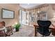 Well lit home office with wood floors, large window and decorative walls at 42019 N Golf Crest Rd, Anthem, AZ 85086