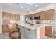Well-lit kitchen featuring stainless steel appliances, and a spacious countertop with barstool seating at 42019 N Golf Crest Rd, Anthem, AZ 85086