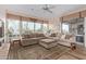 Bright living room with plush sofas, large windows and wood flooring at 42019 N Golf Crest Rd, Anthem, AZ 85086