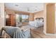 Spacious main bedroom with a seating area, king-size bed, and bright window at 42019 N Golf Crest Rd, Anthem, AZ 85086