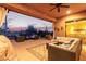 Covered patio with comfortable seating, ceiling fan, and desert views at 42019 N Golf Crest Rd, Anthem, AZ 85086