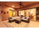 Inviting covered patio with comfortable seating, ceiling fan, and sliding glass doors at 42019 N Golf Crest Rd, Anthem, AZ 85086