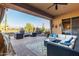Spacious covered patio with plush seating, desert views, and sliding glass door access at 42019 N Golf Crest Rd, Anthem, AZ 85086